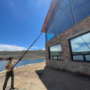 a man is cleaning the windows of a building 