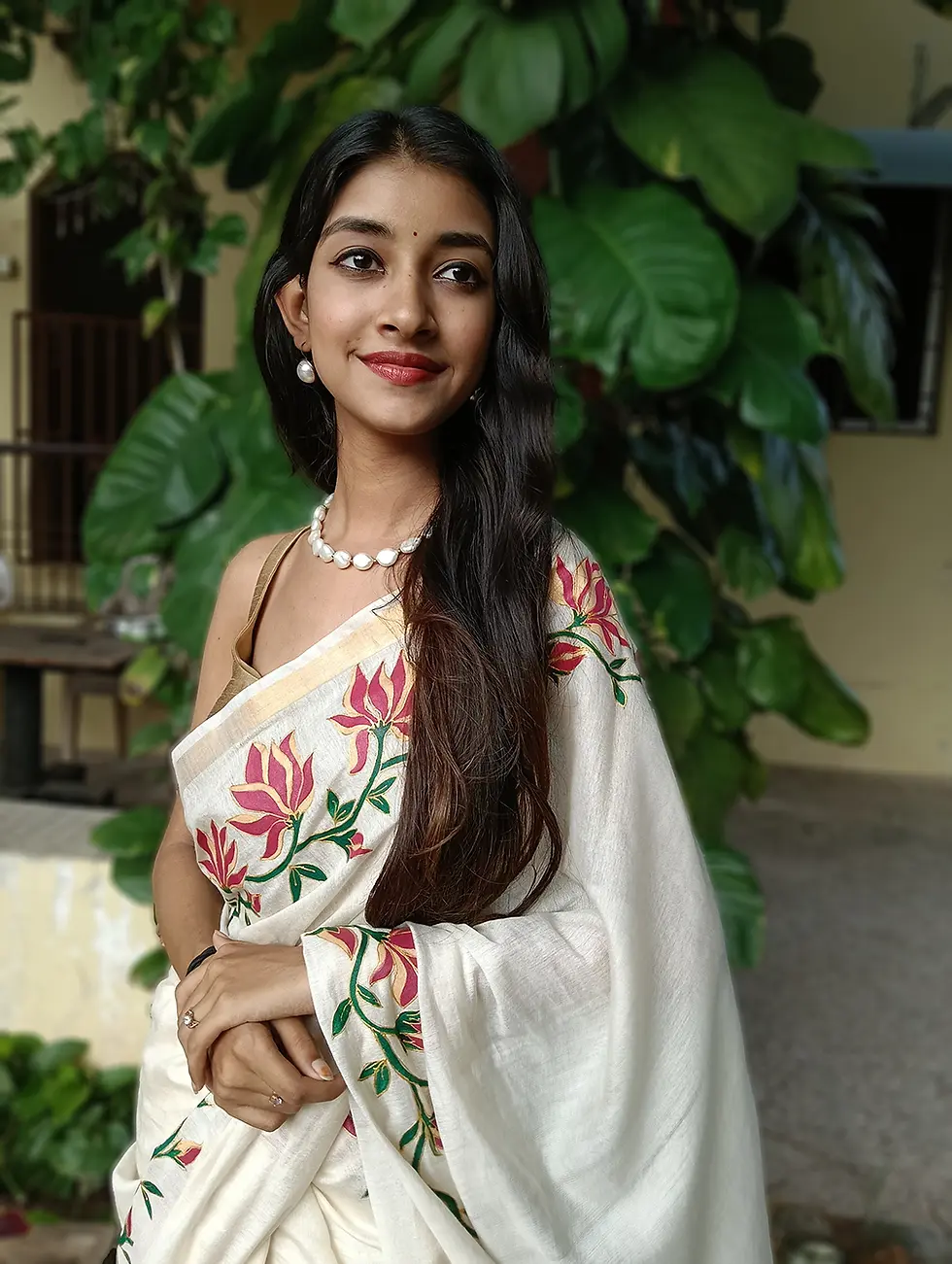Thumbnail: Bhagalpuri cotton silk saree with hand-painted floral border, model smiling outdoors