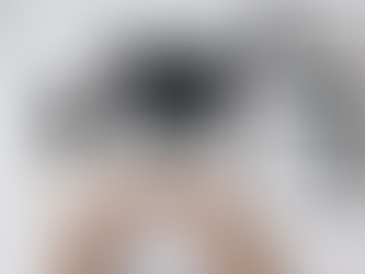 Hands on a laptop with architectural plans, surrounded by a notebook, ruler, pencils, plant, and coffee on a marble desk background.