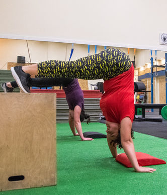 Catalina Mircea performing a Box Pike Handstand Hold, getting ready for a Pike Handstand Push-Up