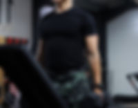 Robert Dobai holding dumbbells, showing a lean, strong torso