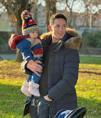 Robert Muresan holding his kid outdoor