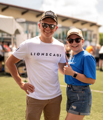 Catalina Mircea and Coach Robert Dobai posing during an outdoor fitness competition