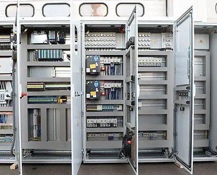 Wide-angle-view-of-multiple-open-PLC-control-cabinets-for-inspection.webp