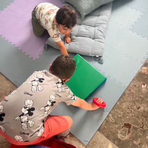 Children playing on soft mats during motor activities at Nissimou center in Spetses.