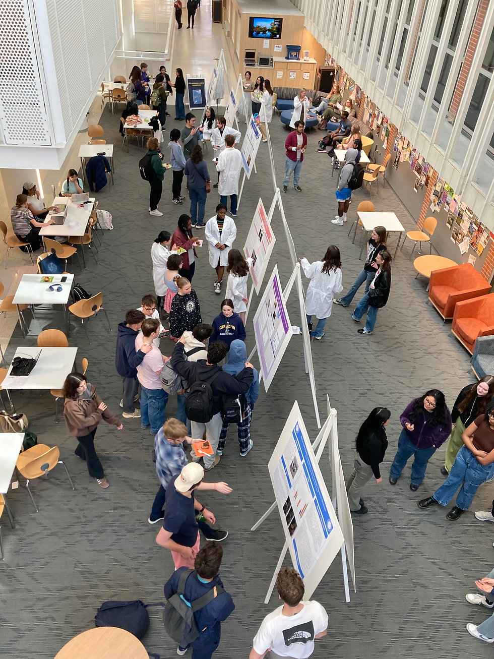 Ariel shot of poster session in which students conducted cognitive research with pigeons and are presenting their findings to the community.