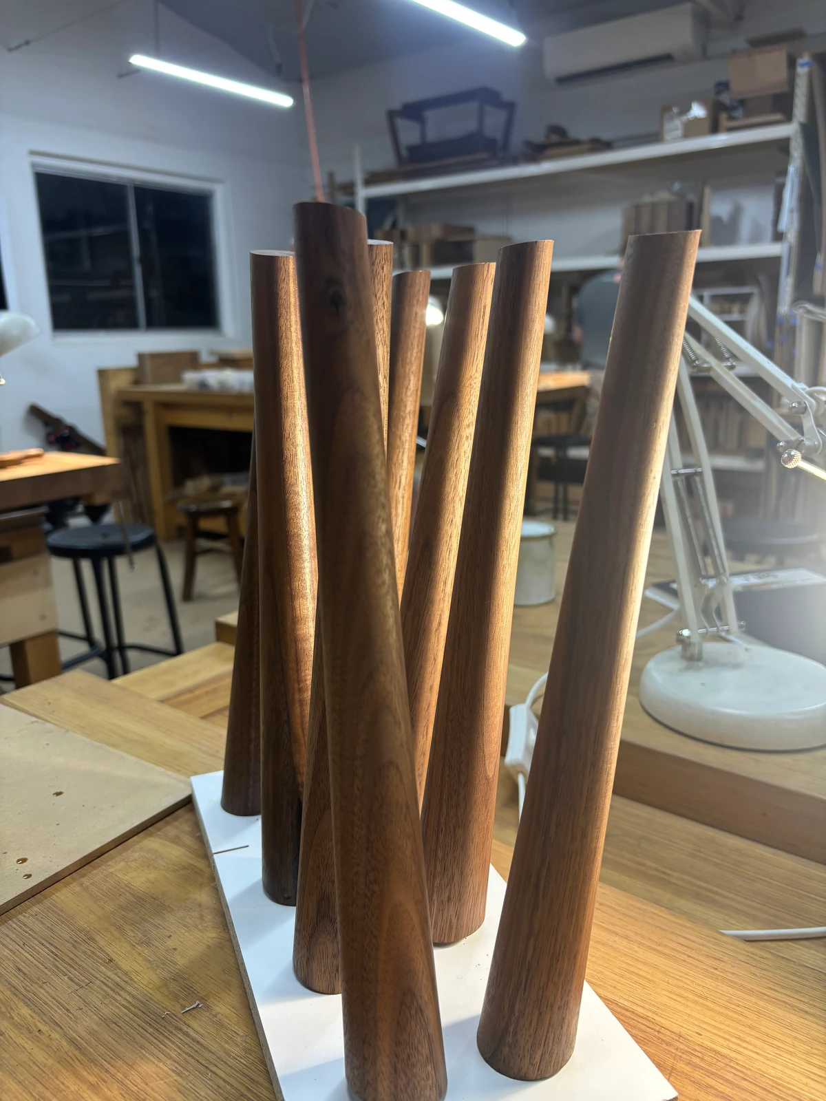 A curved timber chair back being assembled in the workshop.