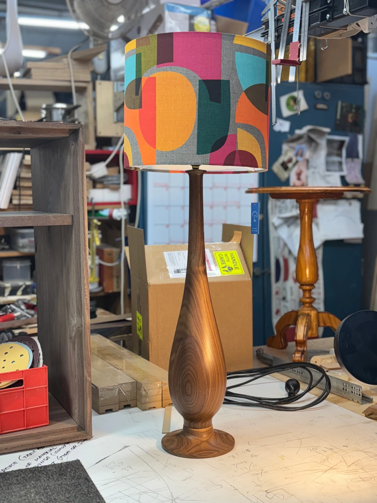 Another view of a turned timber floor lamp and patterned shade.