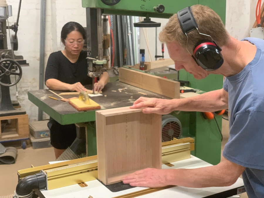 Students preparing timber panels in the workshop.