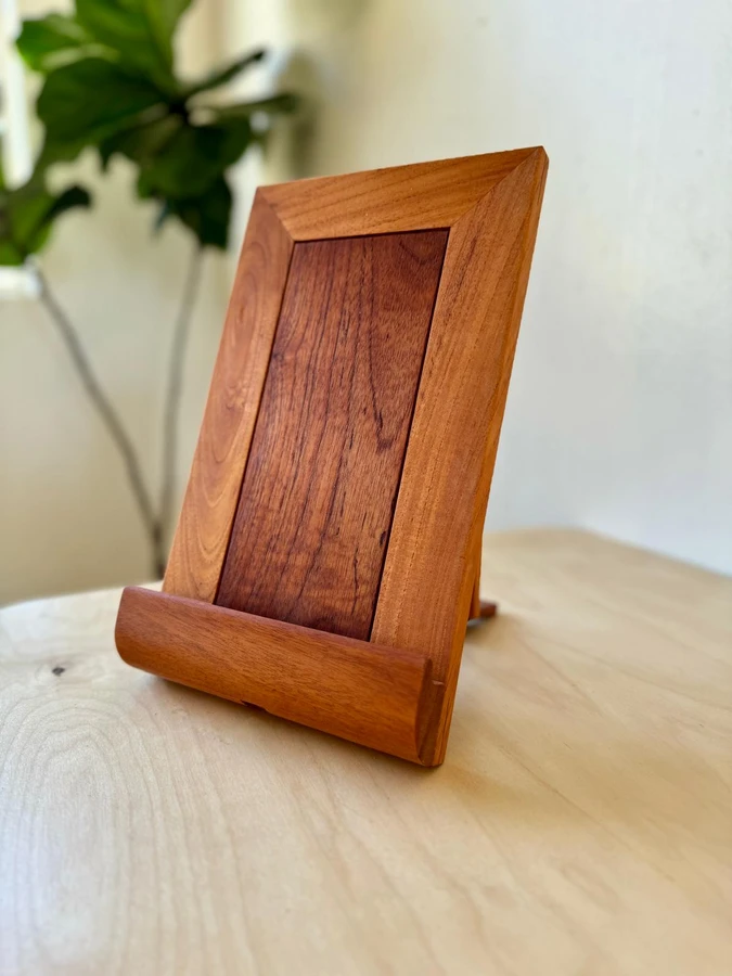 A small freestanding timber picture frame on a shelf.