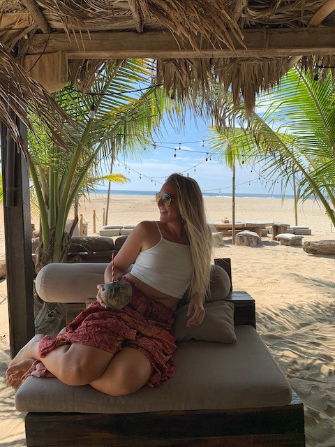 Enjoying a coconut at a beach bar at Playa Zicatela in Puerto Escondido