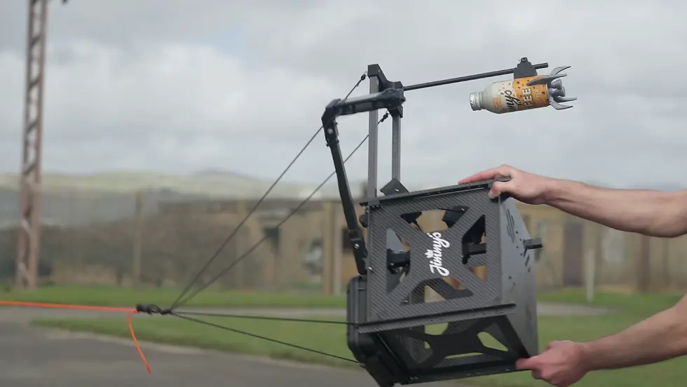 A ready-to-launch Jimmy's Iced Coffee spacecraft being held in a Sent Into Space engineer's hands.