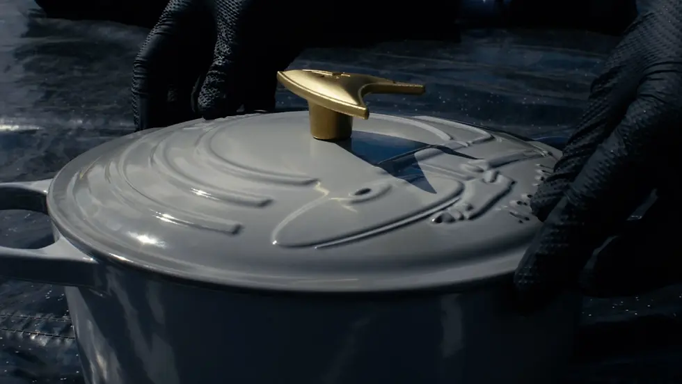 A Le Creuset x Star Trek Casserole held in an engineer's hands