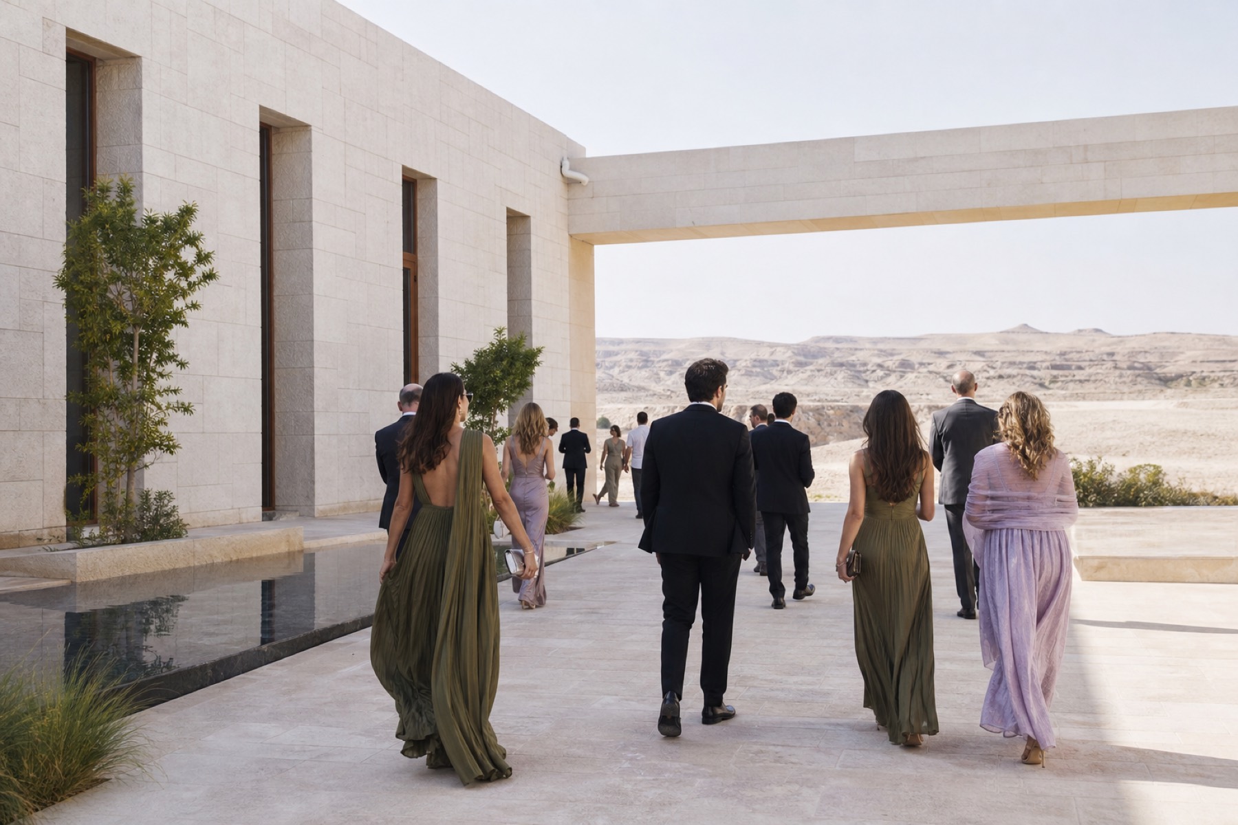 Bright Saudi landscape combining modern architecture and distant desert with elegant guests arriving; no décor.