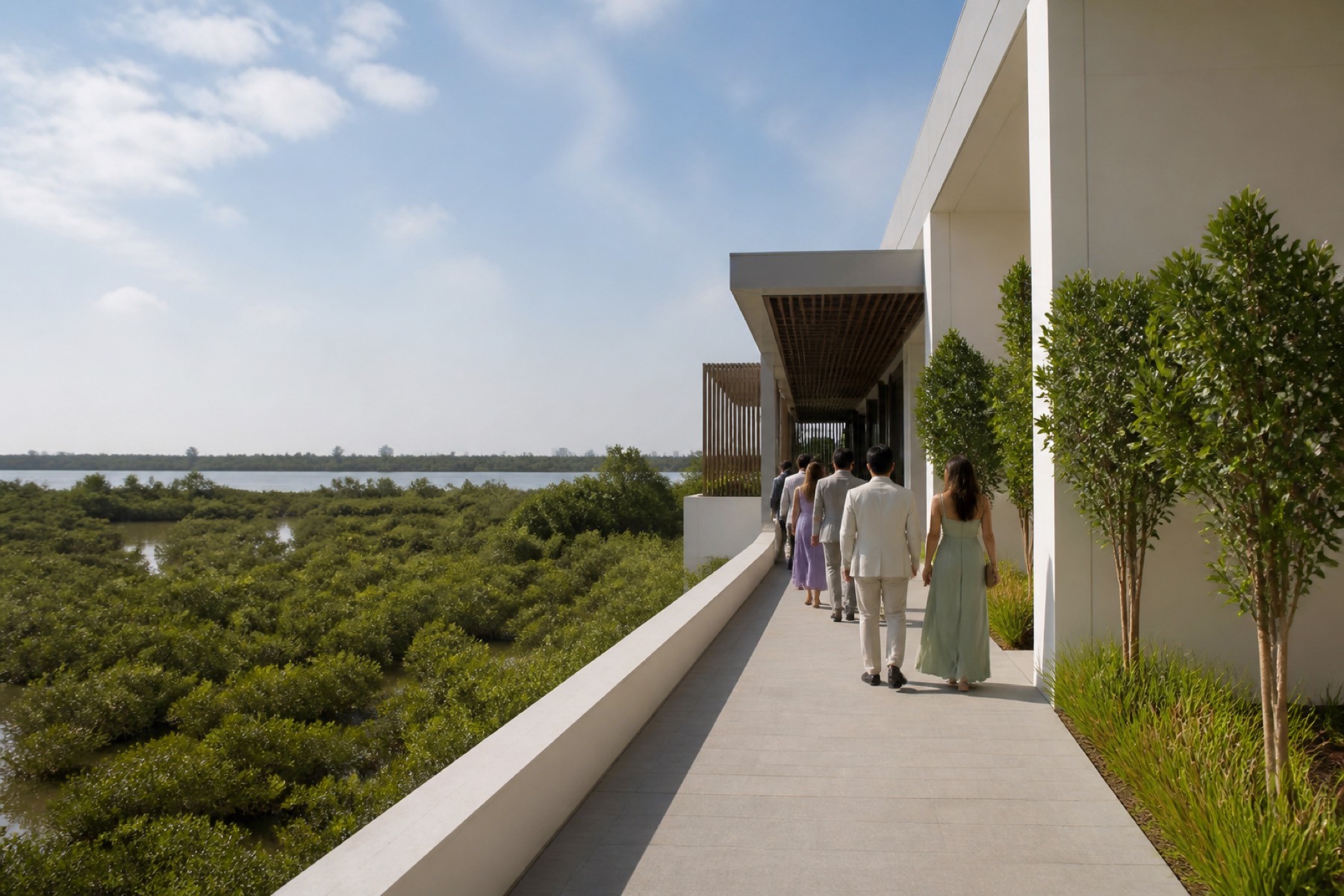 Light aerial view of Al Zorah mangroves and modern resort architecture with guests arriving by walkway; no décor.