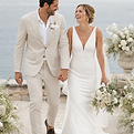 Smiling bride and groom walking hand in hand at a UAE wedding