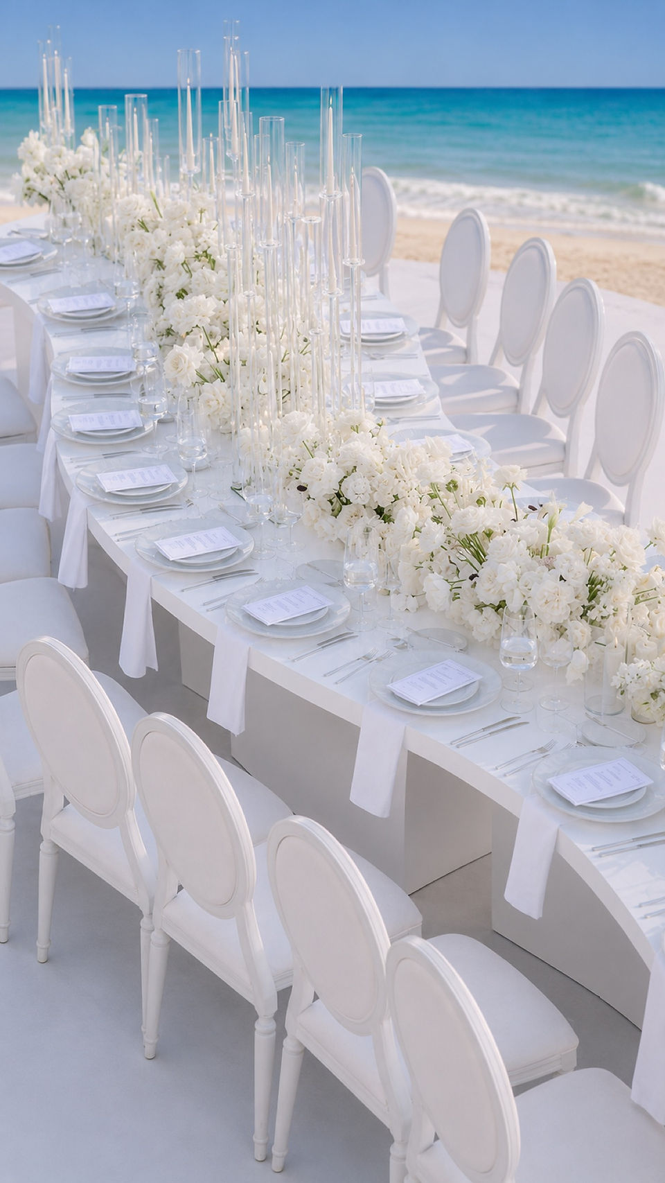 All-white coastal reception table and chairs beside the Abu Dhabi sea