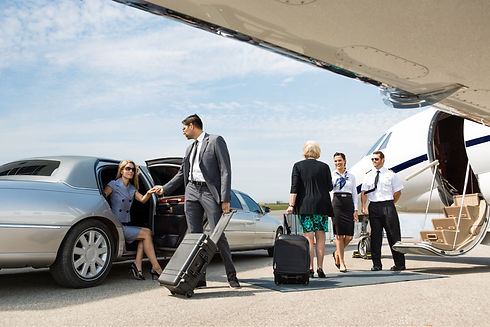 Business partners about to board private jet while airhostess and pilot greeting them.jpg