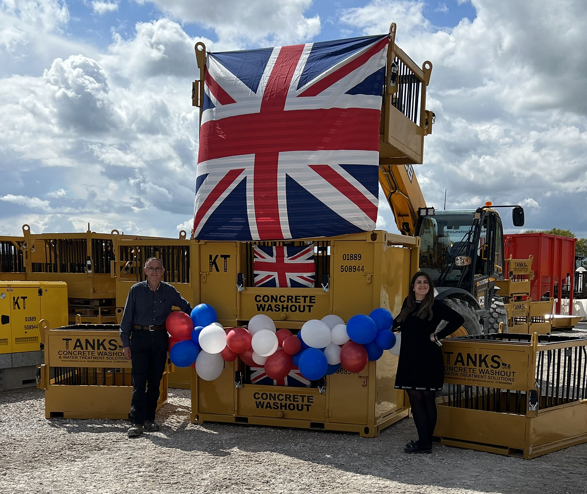 A union jack flag with red white and blue balloons on sack frames for concrete washout