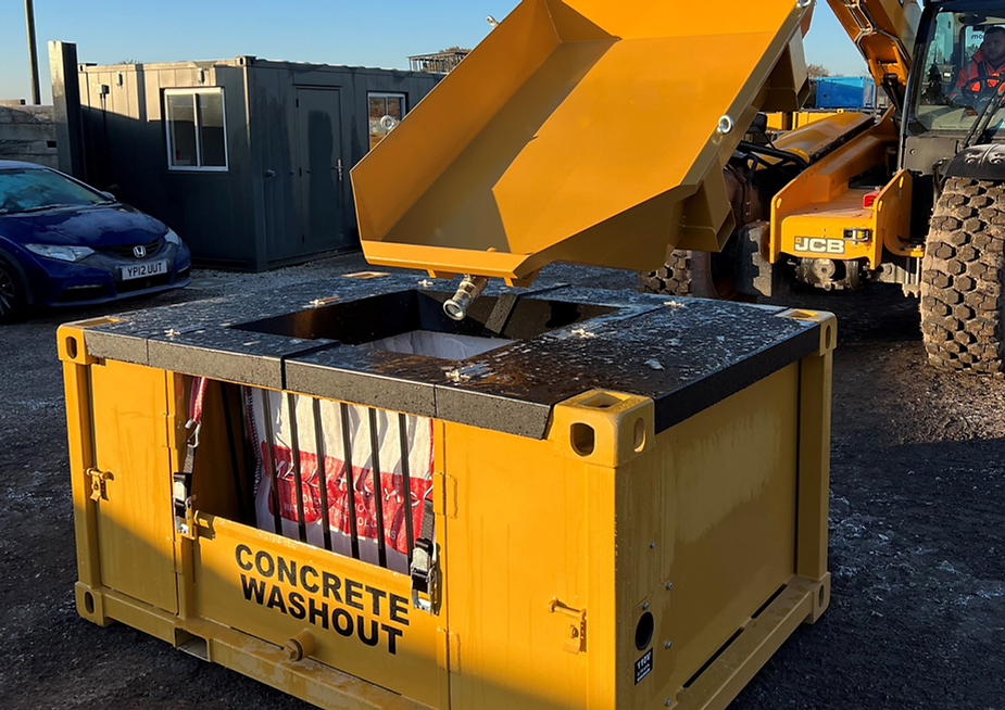 A yellow tapered tray being tipped into a yellow closed-loop concrete washout system.