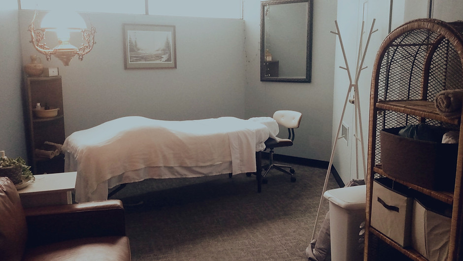 View of clinical space. A massage table prepared for a client. Natural light and clean uncluttered appearance.