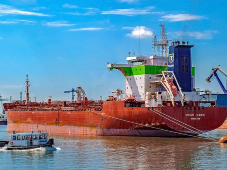 Marine cargo ship carrying containers across the ocean under insurance coverage.