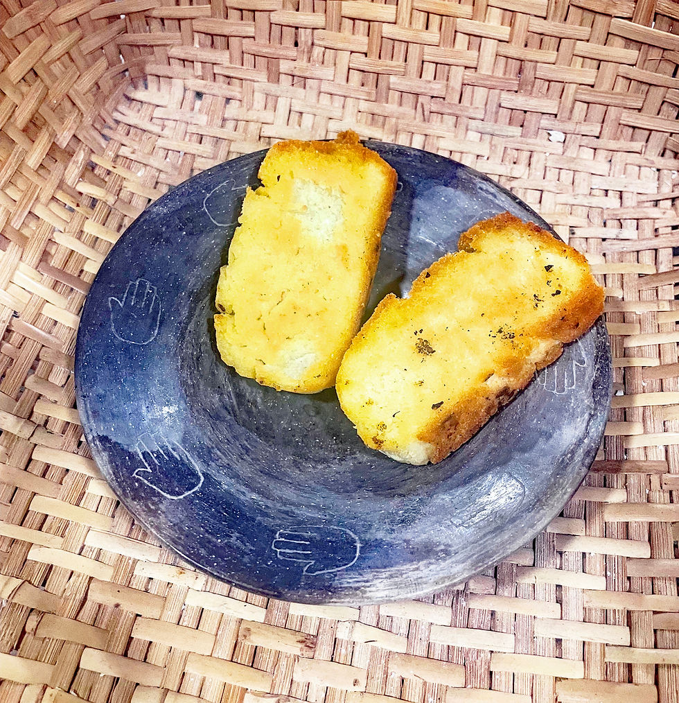Choctaw sour cornbread, made with the recipe above, sliced and fried in olive oil. It's sitting in a bowl that I made from shell-tempered Tombigbee River clay almost 20 years ago.