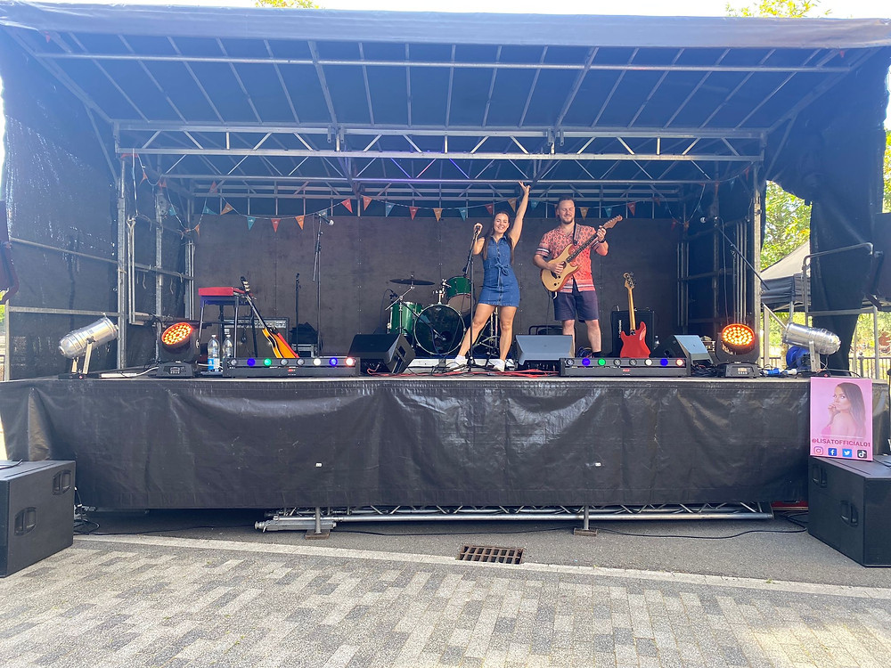 Lisa t and Luke m slater posing on large stage