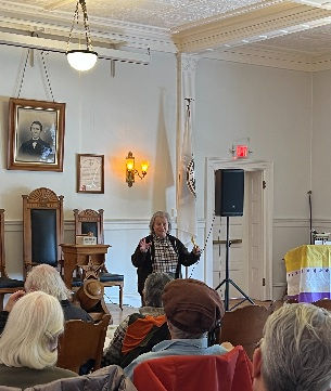 Rachel MacNair speaking to group in historic building