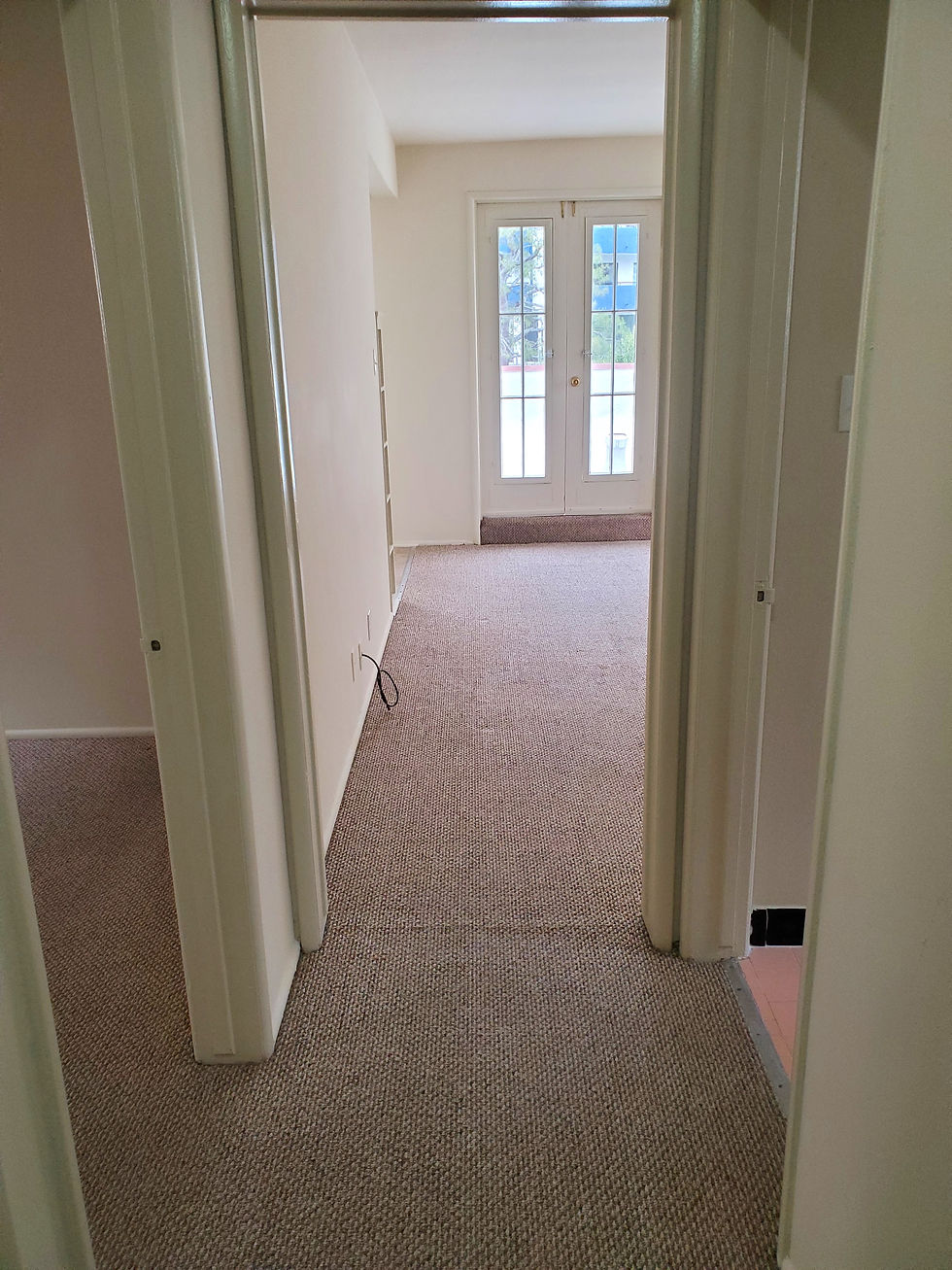 Main hallway leading to the bathroom (on the right), bedroom (on the left) and the living room