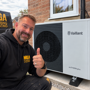 Mike from MGA Plumbing & Heating with an air source heat pump installation in Oldham