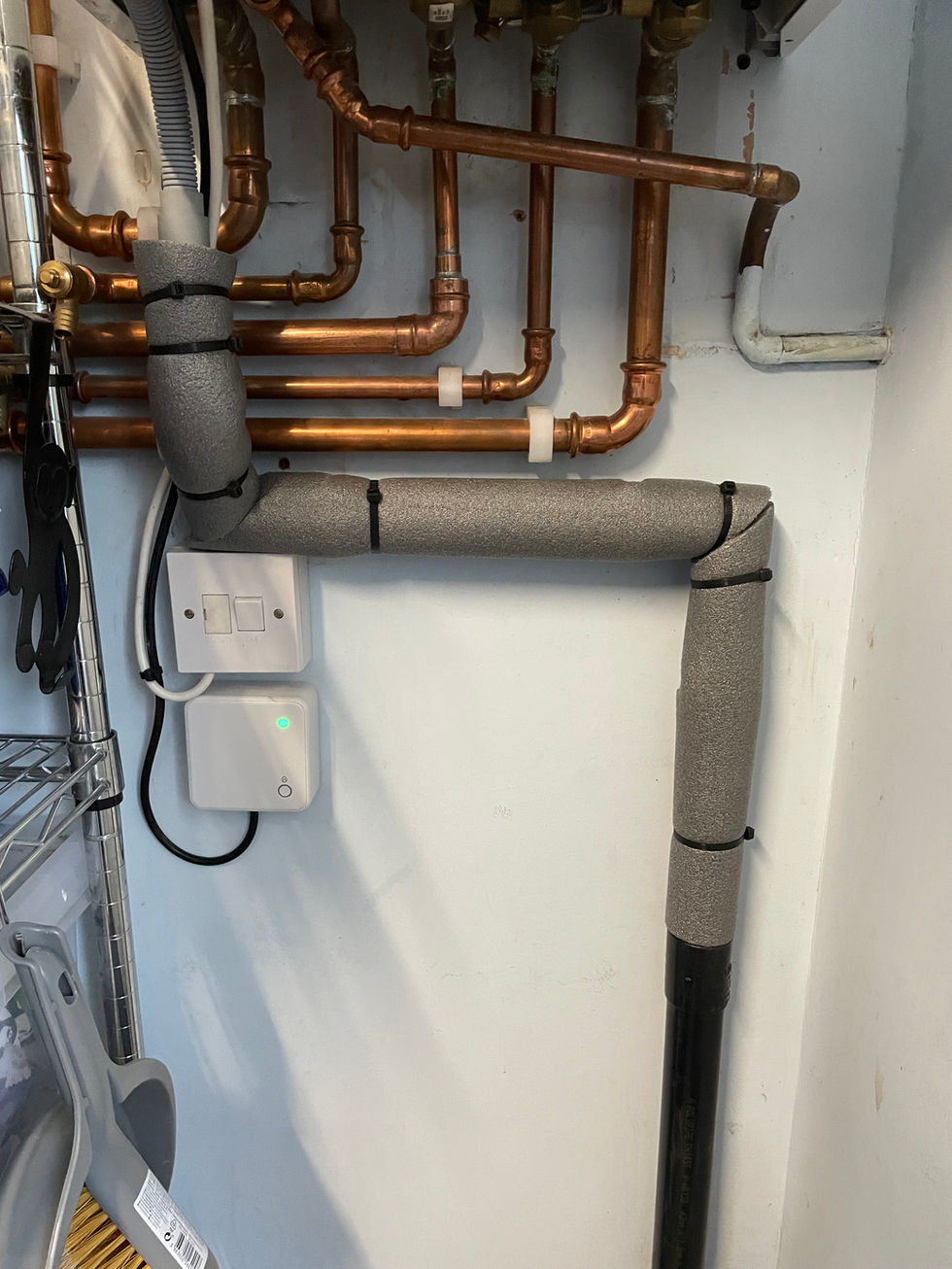 Commercial heating system with neatly installed copper pipework and hot water equipment