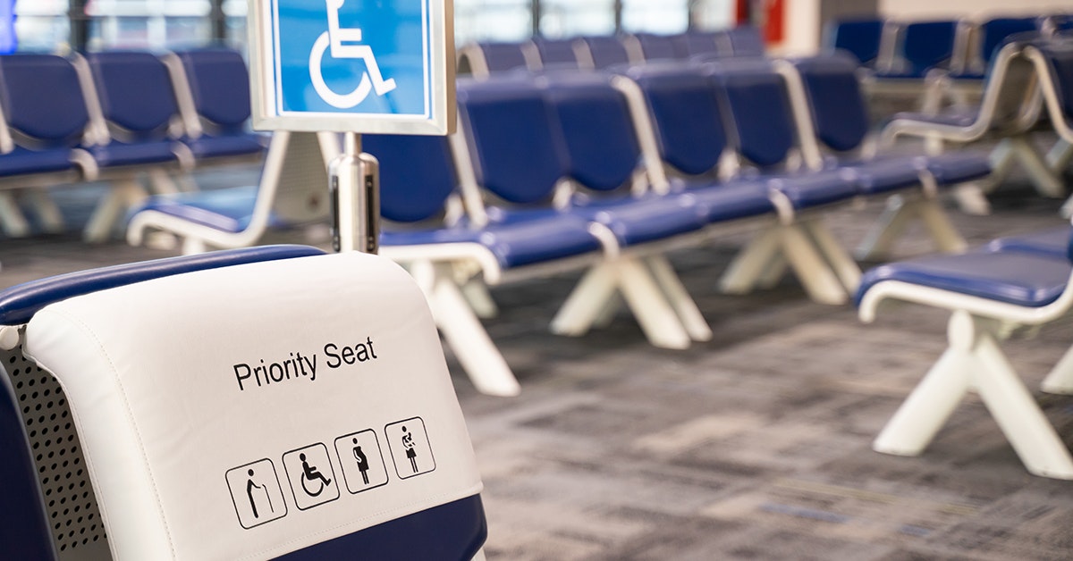 Image of priority seating signage attached to seating in the airport