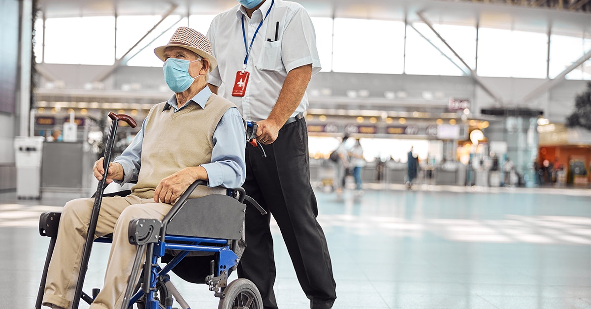 Image of airport staff assisting a disabled customer in a wheelchair