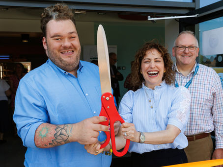 People with giant scissors for the official opening of Campus for Future Living
