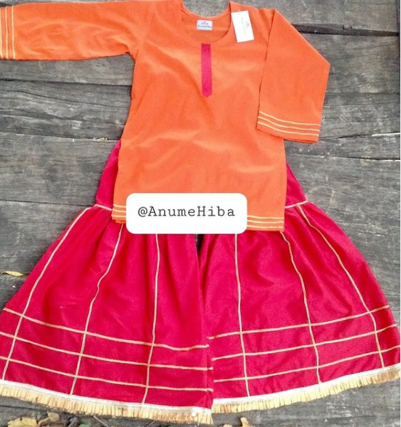 Orange shirt pair with redish pink ghrara