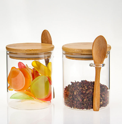 Modern borosilicate glass storage jar with airtight bamboo lid displayed on a kitchen countertop