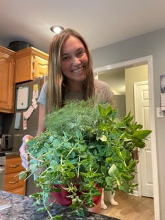 This is an old picture of me from when I first started harvesting and infusing herbs in my mom's kitchen! I loved cutting giant piles of herbs throughout the summer just so I could see how much I could harvest. And with time, I learned how to infuse so many things, and I also learned how passionate I was about it! It's still true to this day!