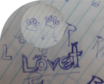 Drawing made with a blue pen of the Lovet logo on a notebook page.
