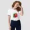 Miniature : T-shirt fraise blanc. Un haut unisexe porté par une femme souriante. Un design inédit imprimé sur un coton bio ultra doux.