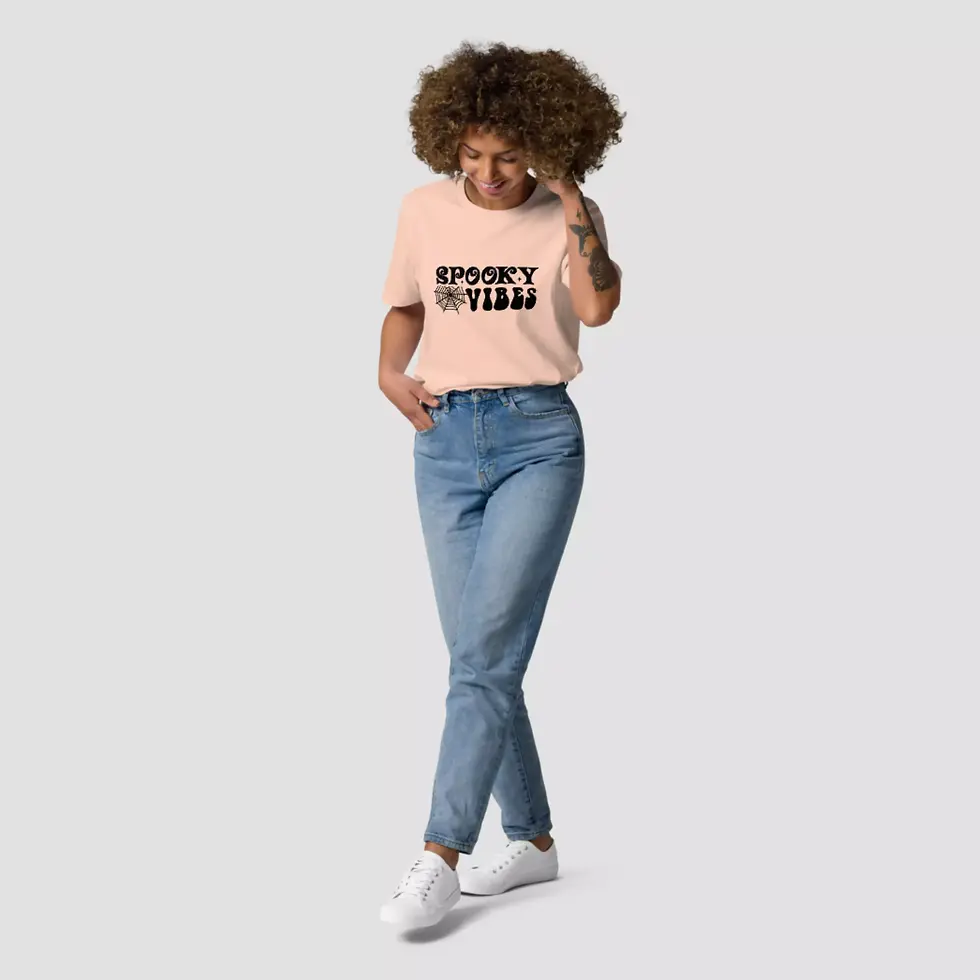 Miniature : T-shirt spooky vibes Halloween de couleur pêche. Une femme est revêtue par ce haut unisexe. Dessin imprimé sur un coton bio.