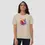 Miniature : T-shirt coquillage unisexe. Ce haut de couleur sable est revêtu par une femme. Une impression réalisée sur un coton bio.