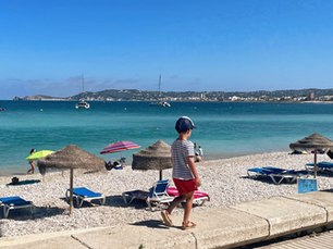 child walking next to a beach