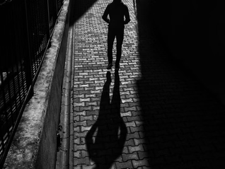 A photo of a man standing in an alley