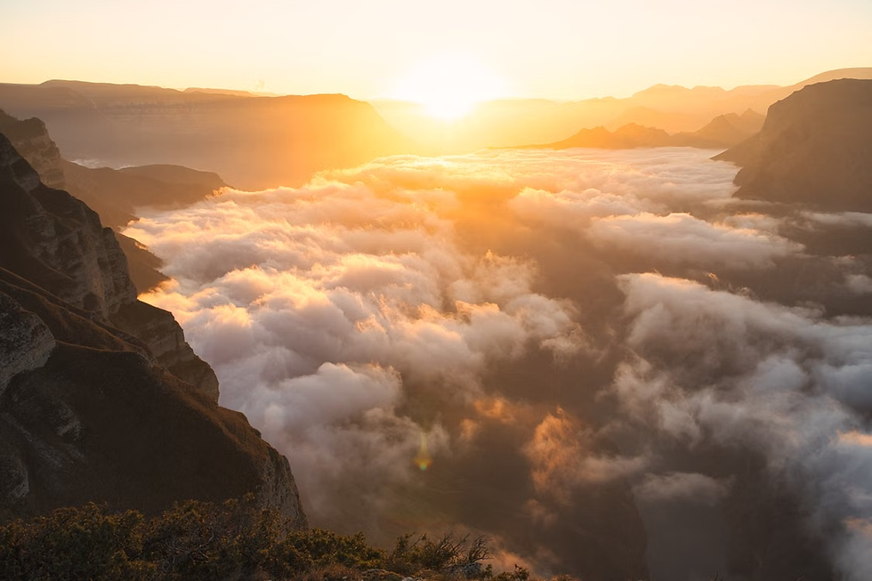 A photo of sunrise over an abyss.