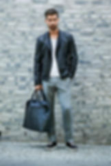 man-with-black-travel-bag