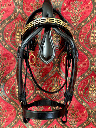 Show quality patent leather gig bridle in horse sized with patent leather and brass chain front