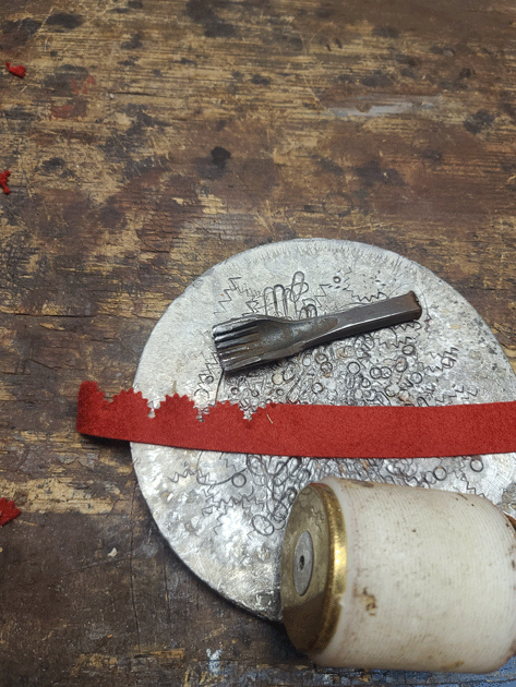 process of hand pinking red wool felt for borders