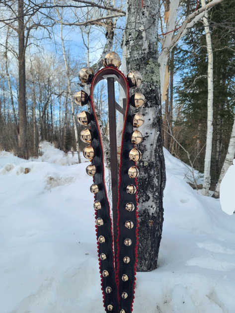 one of a kind string of antique bells on wide, wavy cut leather strap, stamped border and red felt trim