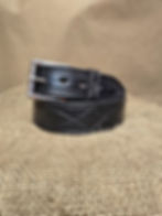1.5" gunslinger stitched black leather belt coiled up on burlap fabric